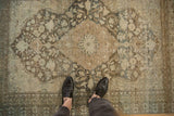 Overhead view of a distressed Mahal rug highlighting its worn texture over the central medallion.