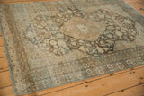 The textured, worn surface of a vintage distressed Mahal rug in neutral coffee and sand tones.