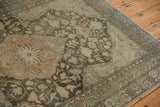 Worn, low-pile texture of a vintage Mahal rug showing its central starburst medallion and tendrils.