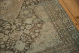 The soft, worn texture of a vintage Mahal rug's corner spandrel and floral borders.