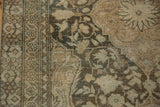Detail of worn texture on a vintage Mahal rug with visible knot heads and coffee brown arabesques.