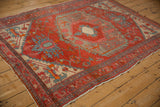 Angled perspective of an antique Northwest Persian rug, highlighting its geometric design and low pile.