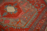 Mostly even wear to knot heads on the hexagonal medallion and geometric border of an antique Persian rug.