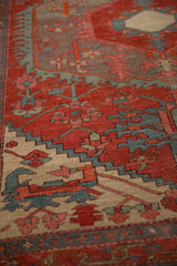 Detailed view of the hand-knotted pile showing geometric motifs and mostly even wear.