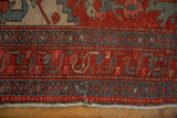 Meandering vine border of an antique Persian rug, showing low pile and foundation at the worn end.