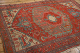 Central geometric medallion of an antique Persian rug showing mostly even wear to the knot heads.
