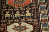 Stylized smiling herds people figures and floral guls on the dark brown, low pile wool.