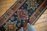 A view looking down at the vintage Persian runner, showing the scale of its bold geometric design.