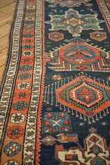 Low angle view of a Persian runner's Karaja-style medallions and intricate side border.