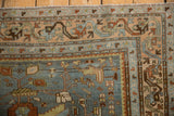 Meandering serpent main border of a distressed vintage Malayer rug in slate blue and sandalwood tones.