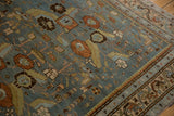 Evenly worn pile on a vintage Malayer rug showing slate blue floral and serpent border details.