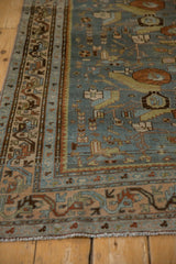 Meandering serpent border in alternating colors on a distressed Persian Malayer rug.