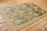 Angled view of a vintage distressed Bijar rug highlighting its dynamic dye lot change.