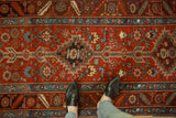 An overhead perspective of the stepped medallions and time-softened pile on an antique Persian runner.