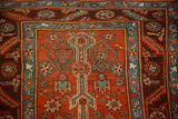 Antique Persian runner's stepped medallion and arrowed barber pole motif in red, blue, and green.