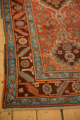 Angled view of a complex border with serrated leaf motifs in sapphire blue, red, and chocolate brown.