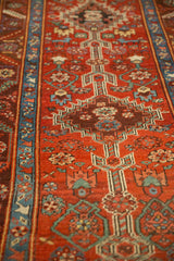 Low-angle view showing the antique runner's stepped medallions and low-pile texture.