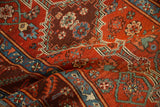 Close-up showing the hand-knotted texture of a stepped medallion and floral border.