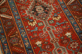 Detail of stylized animal motifs and stepped geometric medallions on an antique Persian runner.