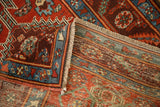 Detailed view of a folded corner on an antique Persian runner, revealing the pile and backside weave.