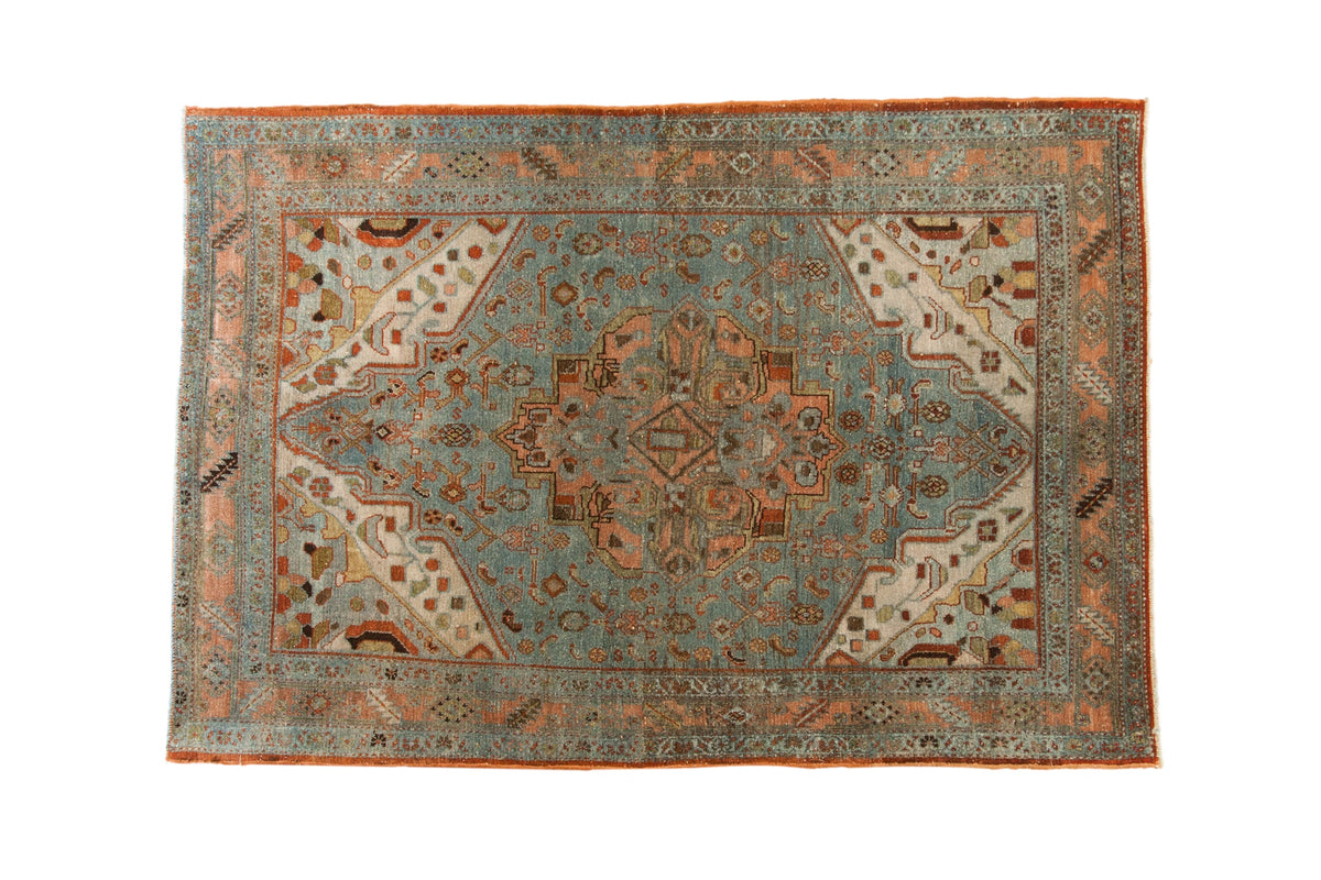 Distressed Malayer rug with central Herati medallion, faded blue, ivory, and rust colors.