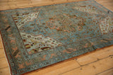 Distressed Malayer rug corner, dusty blue field, ivory spandrel, and serrated leaf border.
