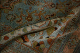 Distressed Malayer rug, close-up view of worn pile and geometric patterns in slate blue, rust, and moss green.