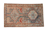 Vintage distressed Malayer carpet with two large serrated medallions in dusty blue, cherry red, and sand.
