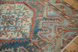 Detail of the worn hand-knotted pile, showing white knots and a serrated border.