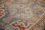Serrated medallion detail with inverted coloration on a distressed hand-knotted Persian Malayer rug.