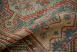 Time-softened pile of a distressed Malayer rug with serrated patterns in red and blue.
