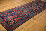 Persian Mehreban runner with navy field, red serrated motifs, blue blossoms, and banded floral border.