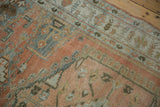 A close-up on the worn, hand-knotted pile revealing the hook-and-latch contour design.