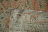 A corner of the vintage Veece rug folded back to show the hand-knotted foundation and weave.