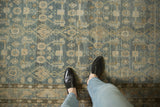 Even wear and low-pile texture of a distressed Hamadan rug in dusty denim blue and sand.