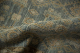 The nubby, distressed texture of a vintage Hamadan rug in dusty blue and sand.