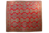 Vintage Oushak carpet with geometric shadow medallions in sky blue and gold on a pomegranate red field.