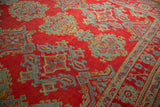 Even wear across the hand-knotted pile of a vintage red and blue Oushak carpet.
