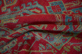 The textured pile of a hand-knotted Oushak carpet shows even wear across the knot heads.
