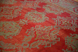 Hand-knotted pile texture of an antique Oushak with slate blue shadow medallions on a red ground.