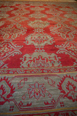 Low-angle view of the hand-knotted texture and even wear on an antique Oushak carpet.