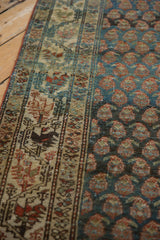 Worn, low pile texture on a Serbend runner's geometric border and sapphire blue boteh field.