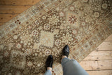 A perspective view of the distressed Afshar runner, highlighting its earthy geometric motifs.