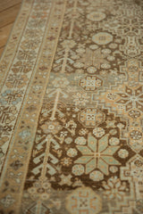 Angled view of the distressed, low-pile texture and geometric starburst motifs of an Afshar runner.