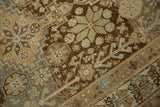 Detailed weave of a vintage Afshar rug with starburst motifs in slate blue on a chocolate brown field.
