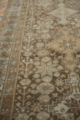 Geometric patterns and low-pile texture in coffee brown and slate blue on a vintage Afshar runner.
