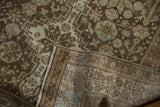 Folded corner of a vintage Afshar runner showing the reverse hand-knotted weave and bound edge.