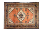 Vintage Lilihan carpet with a central diamond medallion, an abrashed copper-rose field, and intricate navy borders.