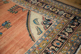 Ivory corner spandrel with shrimp-like fish motifs on a vintage hand knotted Persian Lilihan carpet.