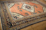 Intricate navy and gold borders meet the ivory corner spandrel of this vintage Lilihan carpet.